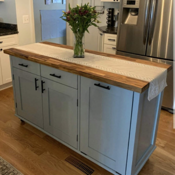 white and wood top kitchen island in white kitchen